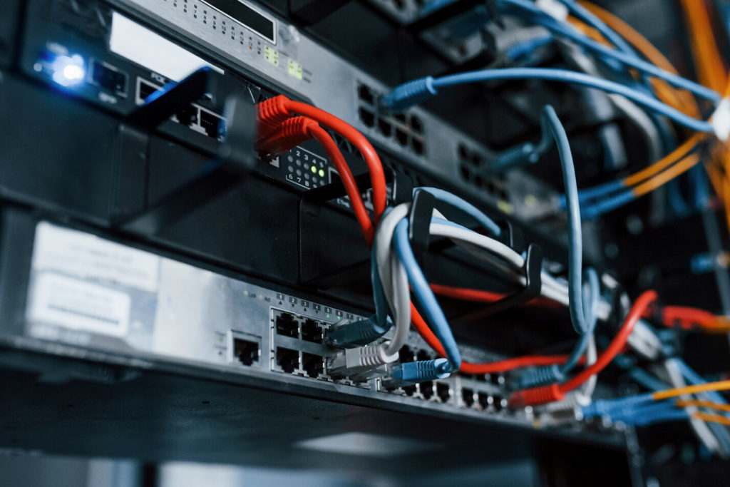 Support & Maintenance 2 Close up view of internet equipment and cables in the server room